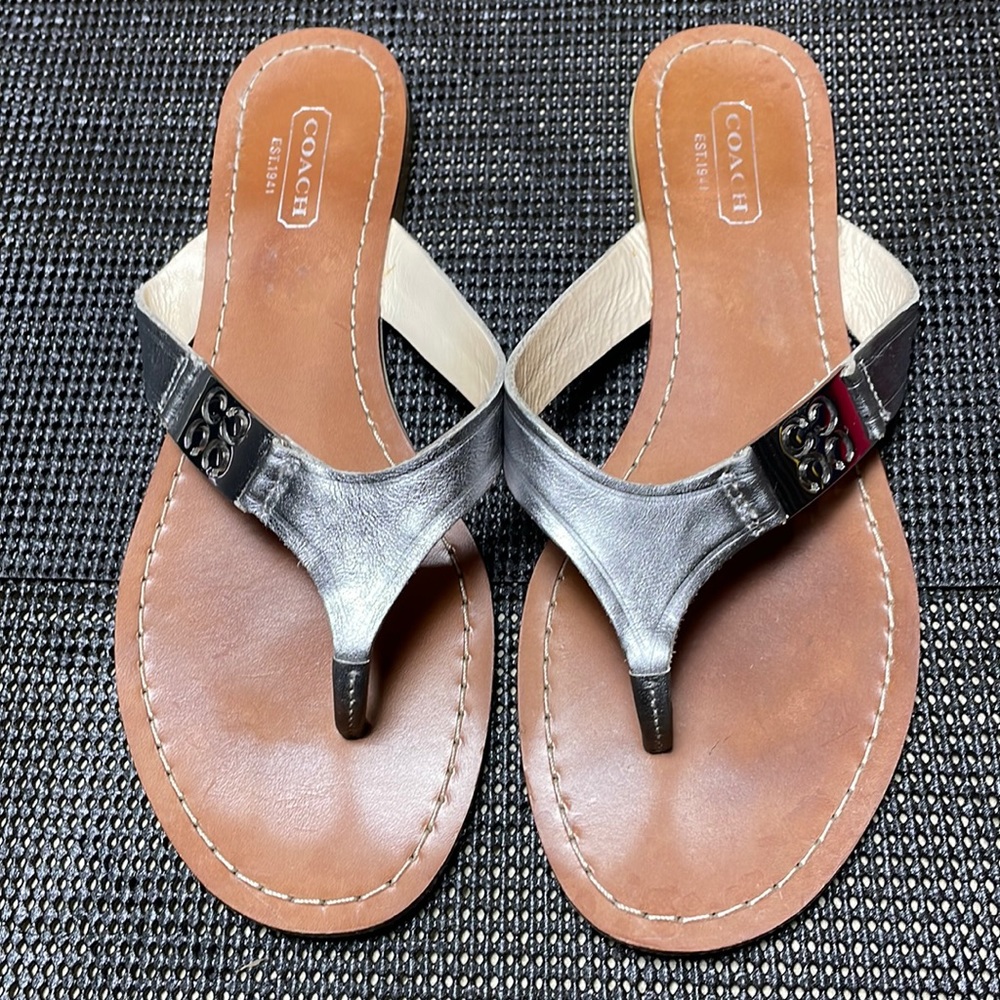 Coach leather flat women’s sandals with silver hardware and strap size 7B